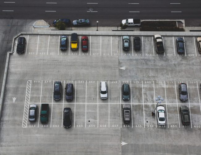 Image of parking lot with a few cars, fairly empty. Could be optimized with GrydPark.